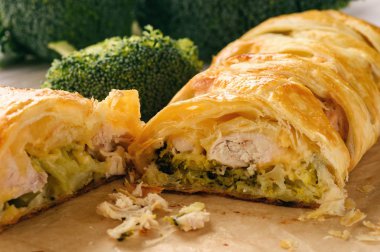 Homemade pie stuffed with broccoli, chicken and cheese. clipart