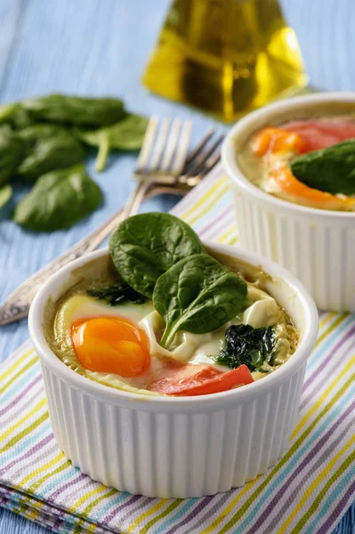 Fit food- eggs baked with spinach and tomatoes.