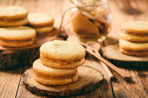 Caramel shortbread cookies on wooden background.