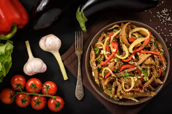 Asian style eggplant spicy salad on black background. Top view. — Stock Photo, Image