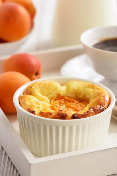 Hausgemachter Käsekuchen mit Aprikosen auf weißem Holzblech. — Stockfoto