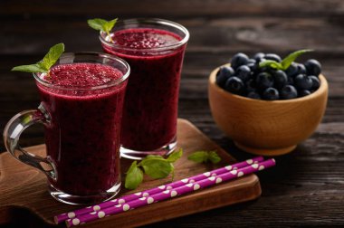 Sağlıklı içecek - blueberry smoothie ahşap arka plan üzerinde.