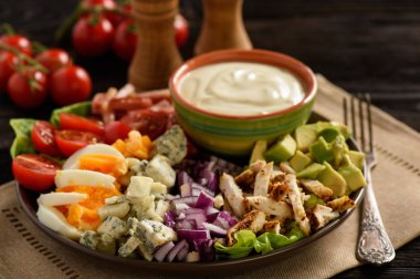Salad cobb- avocado, tomatoes, bacon, chicken and onion. clipart