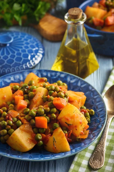 Cibo vegetariano - patate con piselli e pomodori, cucina in stile greco . — Foto Stock