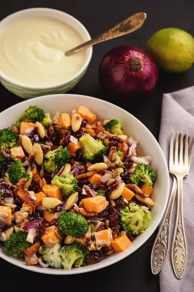 Broccoli salad with yogurt dressing, cheese, bacon, almond and cranberries.