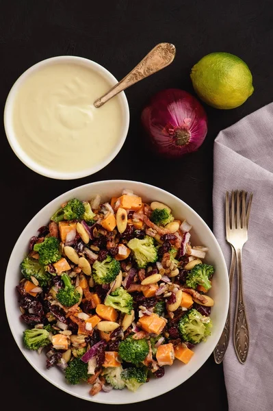 Broccoli salad with yogurt dressing, cheese, bacon, almond and cranberries.