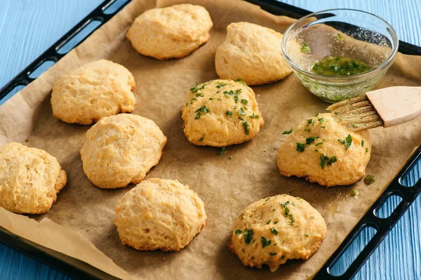 Homemade garlic cheese biscuits on wooden background.