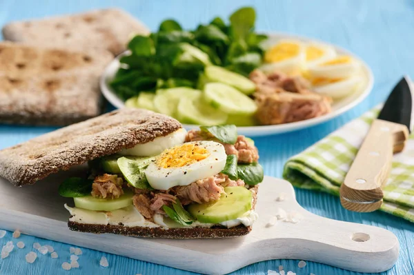 Tuna salad sandwiches with eggs and cucumbers.