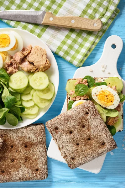 Tuna salad sandwiches with eggs and cucumbers.