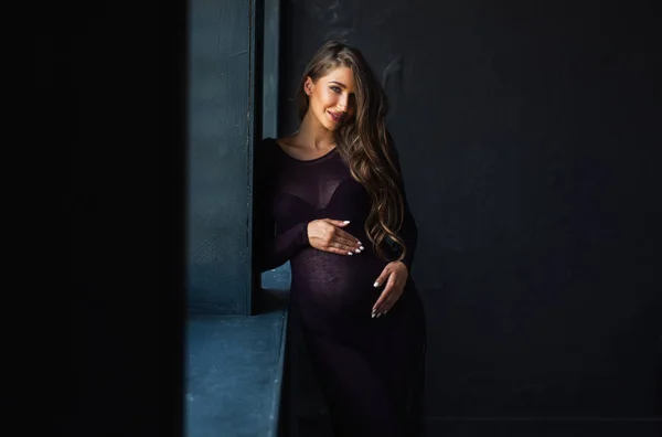 Pregnant woman  in black dress posing — Stock Photo, Image