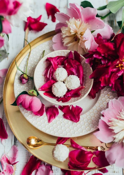 composition of peony flowers and dessert on table, Spring concept