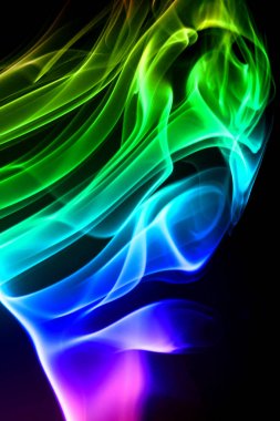Multicolored smoke isolates on a black background clipart