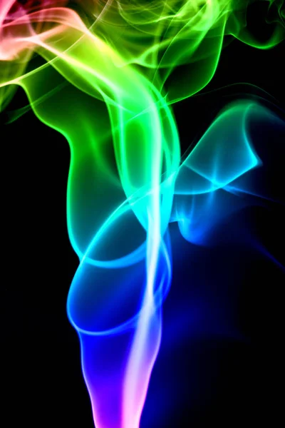 Multicolored smoke isolates on a black background — Stock Photo, Image