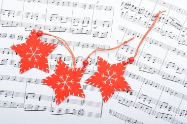 Christmas decorations lying on notes sheet clipart