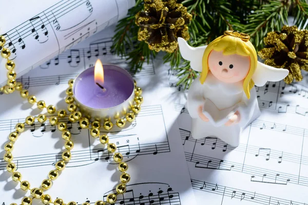 Christmas decorations, candles, figures of angels and notes — Stock Photo, Image