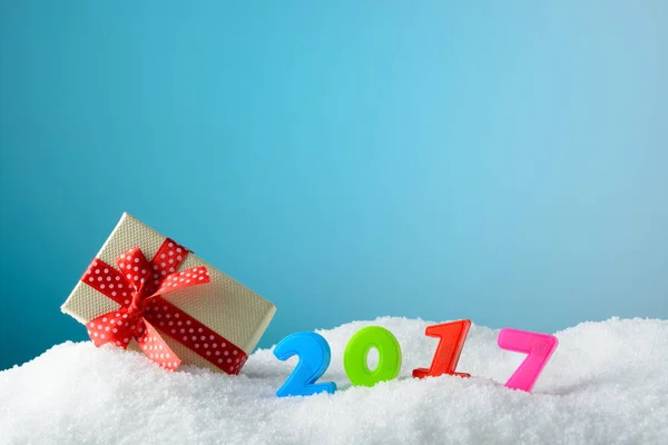 Cijfers 2017 en cadeau doos op sneeuw — Stockfoto