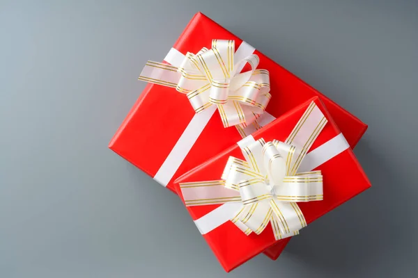 Two red gift box with a white ribbon and a bow — Stock Photo, Image