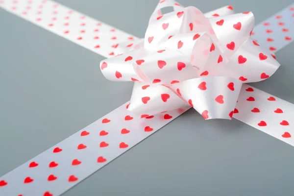 White bow and ribbon with hearts