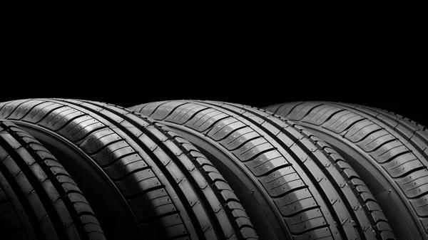 Car tires on black background — Stock Photo, Image