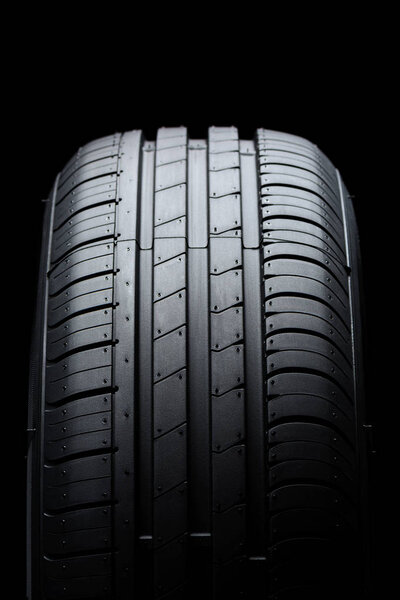 Car tire on black background