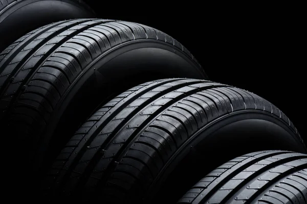 Car tires on black background — Stock Photo, Image