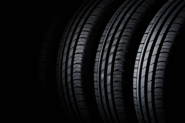 Car tires on black background — Stock Photo, Image