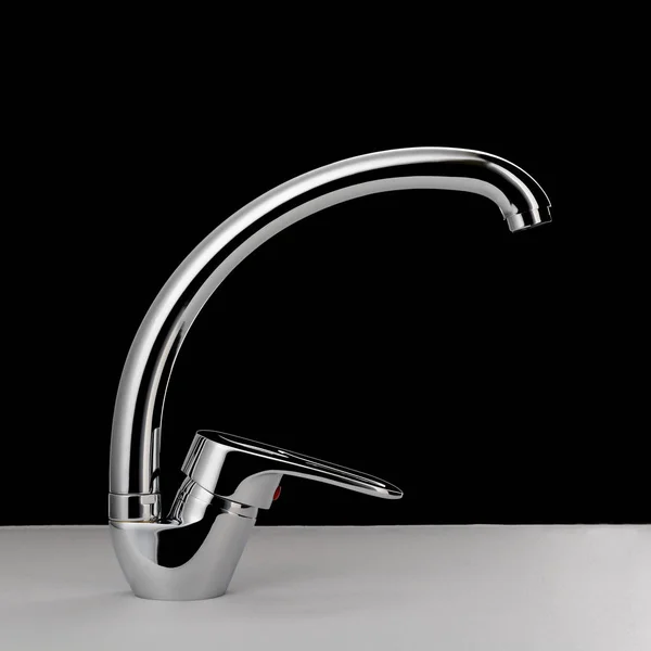 Water faucet on black background — Stock Photo, Image