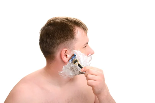 A man shaves on a white background — Stock Photo, Image