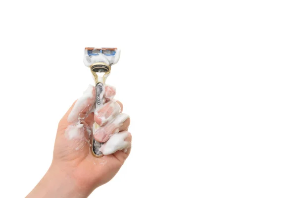 Male hand in the foam holds the razor on a white background — Stock Photo, Image