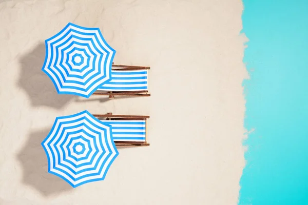 Beach furniture under umbrellas — Stock Photo, Image