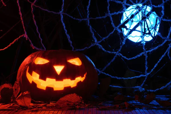 Orribile zucca di Halloween sullo sfondo del web e della luna piena — Foto Stock