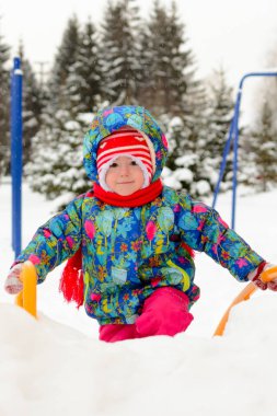 Kışın parkta oynarken küçük kız