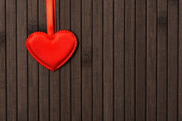 Small red heart hanging on the ribbon — Stock Photo, Image