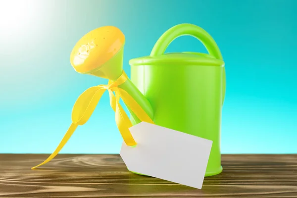 Watering can with blank label — Stock Photo, Image