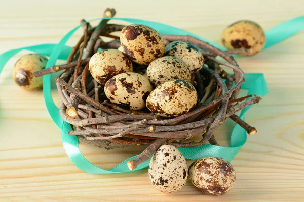 Quail eggs with ribbon in nest — Stock Photo, Image