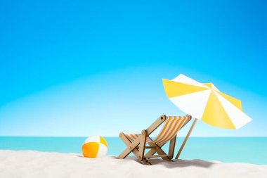 Şezlong şemsiye ve plaj topu deniz kenarı