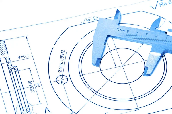 Measuring and drawing instruments and drawings on the table. Toning in trendy color 2020 classic blue.