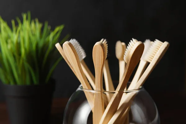 Close up of several bamboo toothbrushes in a glass cup. — 图库照片