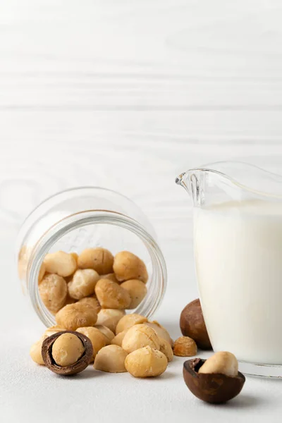 Dairy-free milk. Macadamia nut milk on a light background.