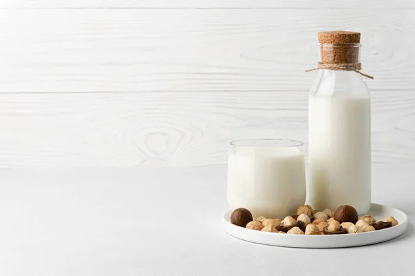 Dairy-free milk. Macadamia nut milk on a light background.