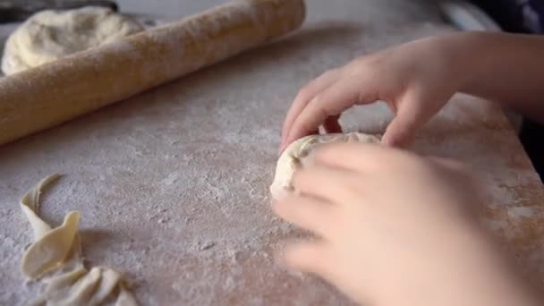 Little girl sculpts pies with potato filling. Handmade homemade cakes. — Stock Video