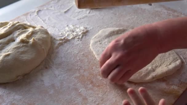 Little granddaughter helps her grandmother make pies. — Stock video