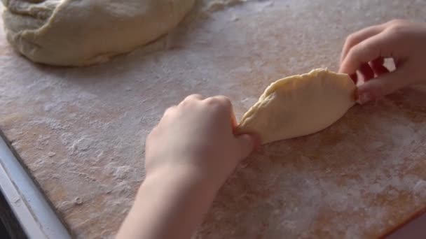 Little girl sculpts pies with potato filling. Handmade homemade cakes. — Stockvideo