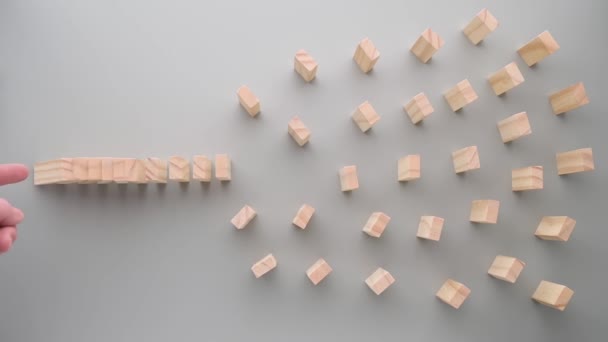 Hand duwt dominostenen, domino-effect stopt als gevolg van grote afstand — Stockvideo