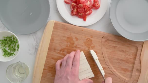 Chef cuts feta cheese. Vegan food. Summer refreshing salad. — Stock Video