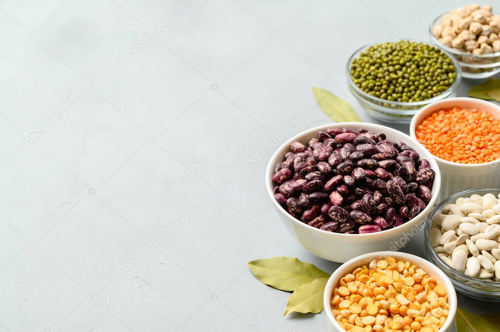 Various sources of vegetable protein: beans, lentils, peas, chickpeas, mung bean in bowls. A healthy balanced diet for vegans and vegetarians.