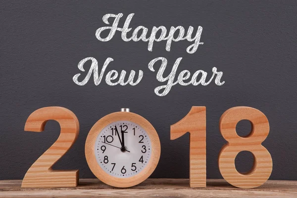 Happy new year 2018 on desk with wooden clock