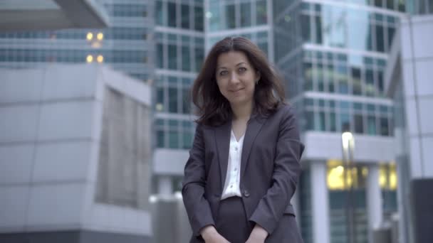 Female employee is standing near business center — Stock Video