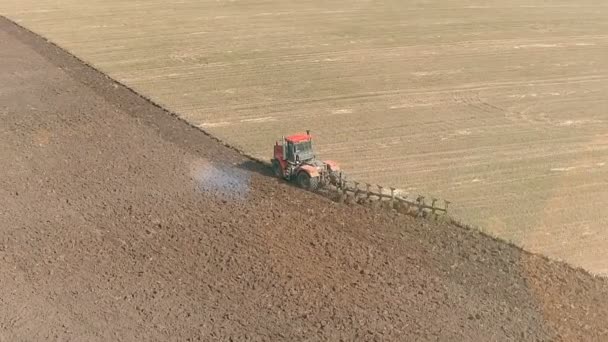 トラクターのアリアルショットは、耕起とフィールドを耕す — ストック動画