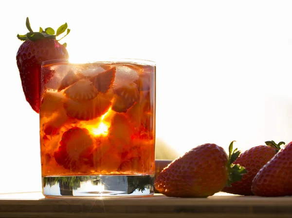 Fresh made Strawberry Caipirinha on green blurry background — Stock Photo, Image